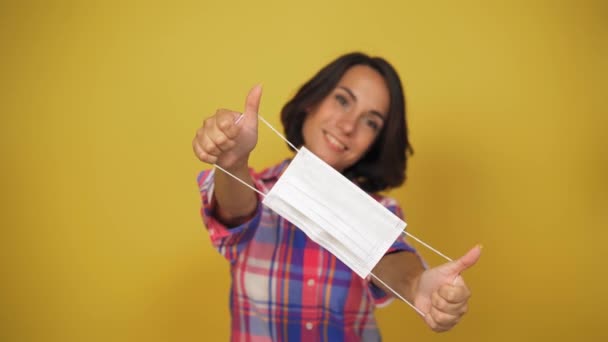 Middle aged woman with brown hair show white pollution mask. Like sign. Quarantine conception. Royalty Free Stock Footage