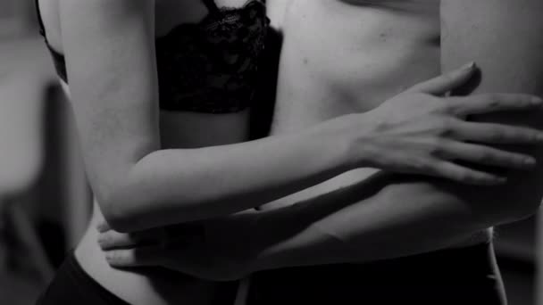 Dospělý muž a žena ve spodním prádle se jemně objímají a drží se za ruce. Těla milenců. Černobílá střelba. Vysoce kvalitní 4K záběry — Stock video