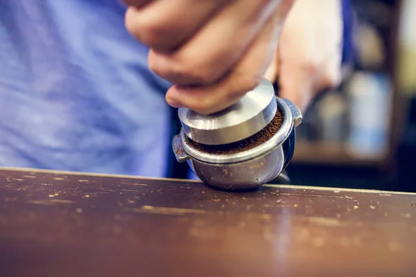 Foto de hombre barista con mortero con café en las manos —  Fotos de Stock