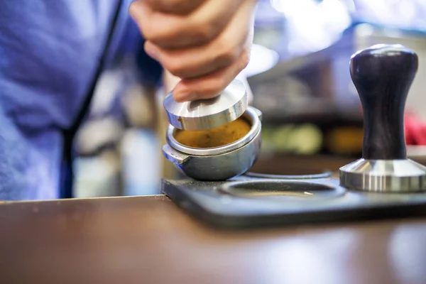 Image of barista man with mortar with coffee — Stock Photo, Image
