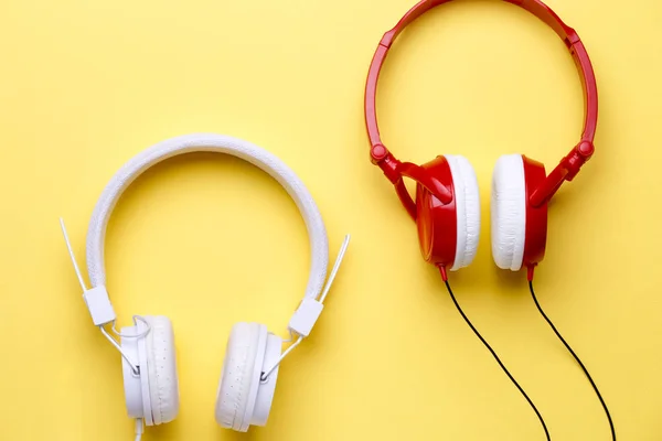 White and red headphones on empty yellow background — Stock Photo, Image