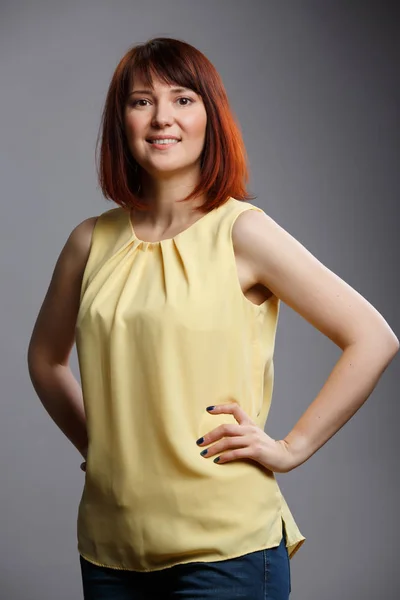 Photo of young woman on gray blank background — Stock Photo, Image