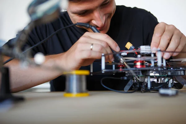 Image of man with soldering iron repairing mechanism — Stock Photo, Image