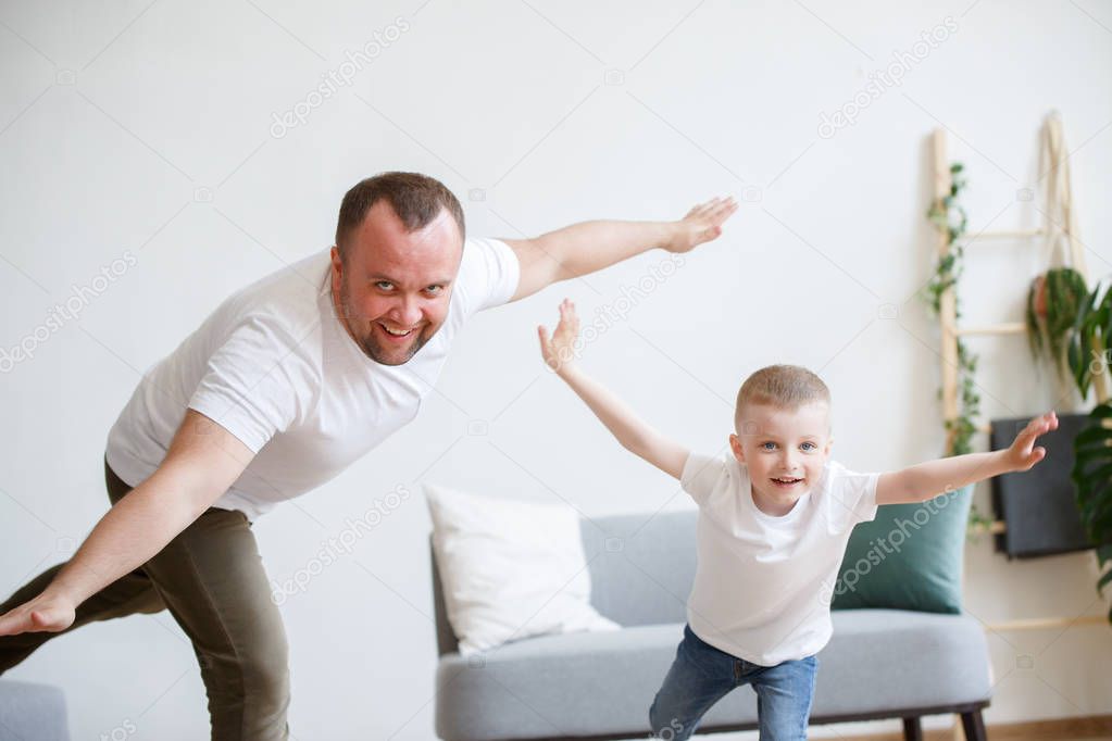 Image of young father with son playing in plane