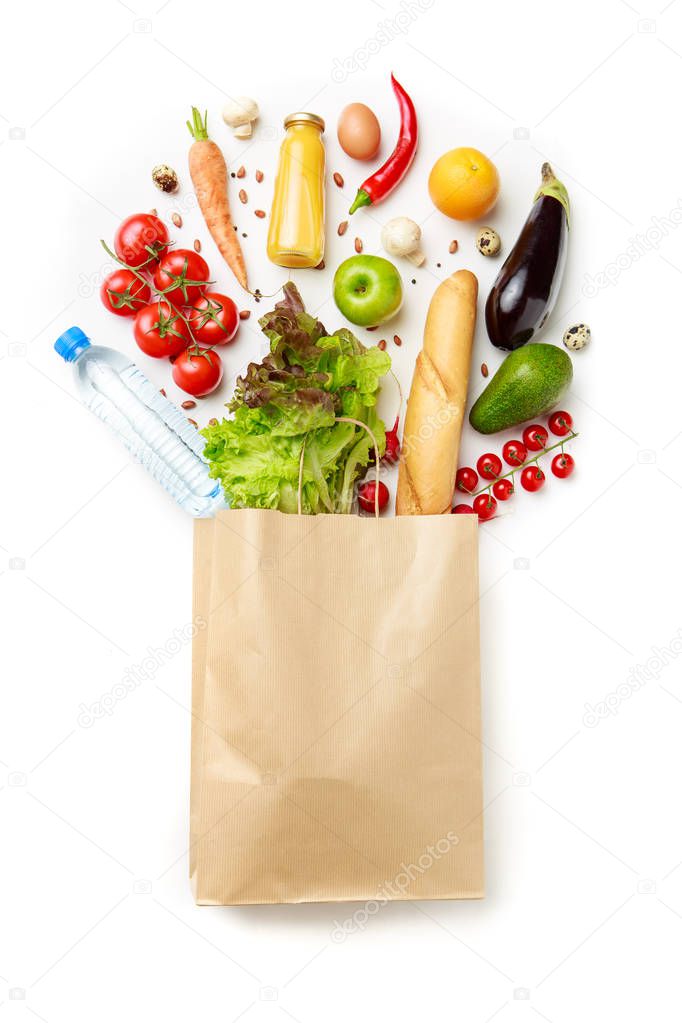 Image of paper bag with vegetables, juice, orange, loaf