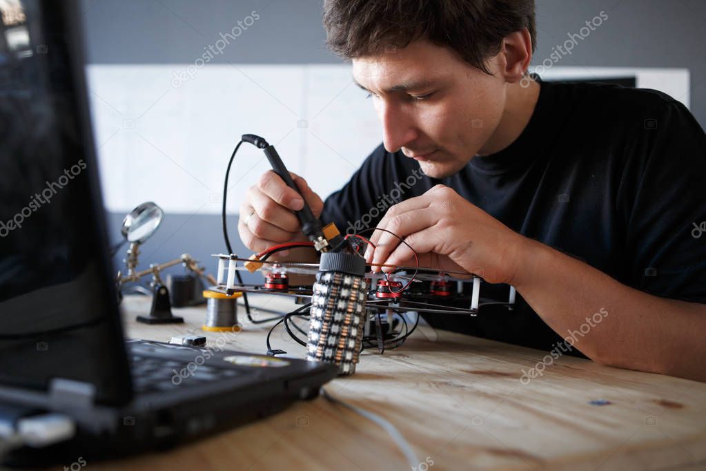 Picture of engineer with soldering iron repairing mechanism