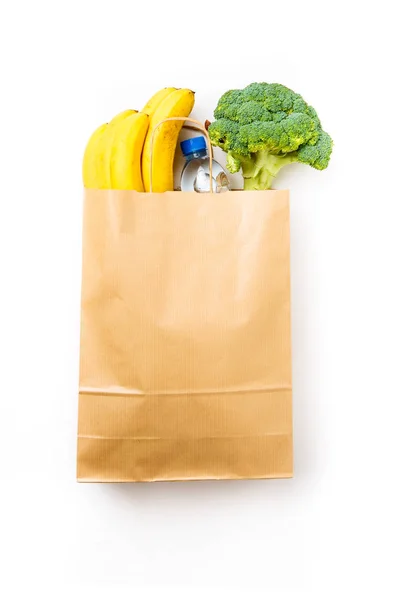 Foto de bolsa de papel con brócoli y plátanos, botella de agua — Foto de Stock