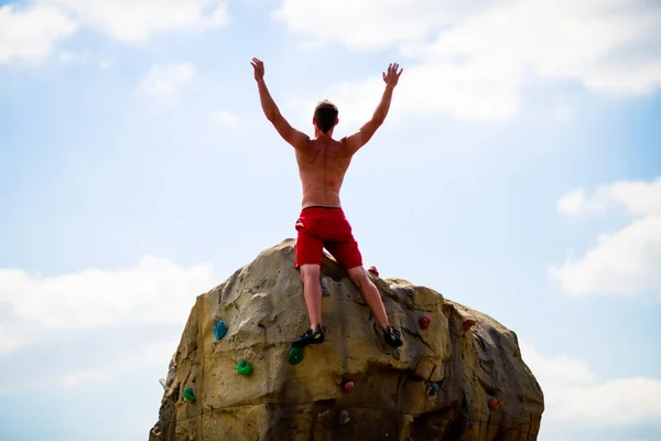 Foto vom Rücken eines Bergsteigers auf einem Stein — Stockfoto