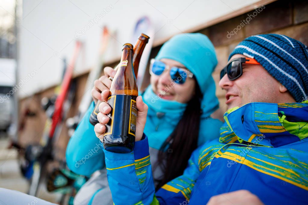 Photo of cheerful tourists with beer on winter day