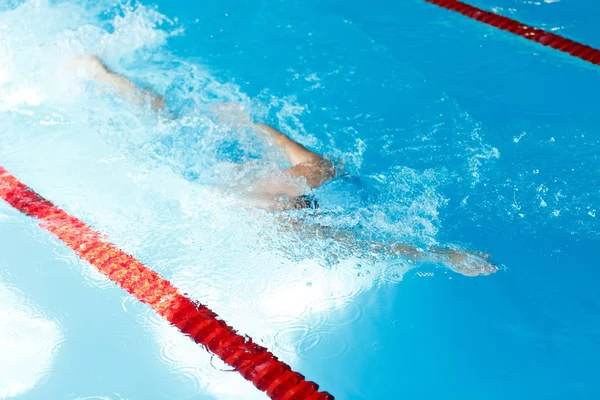 Bild eines Mannes, der unter Wasser im Schwimmbad schwimmt — Stockfoto