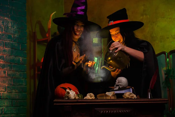 Photo of witches with pot of magic poison and steam — Stock Photo, Image