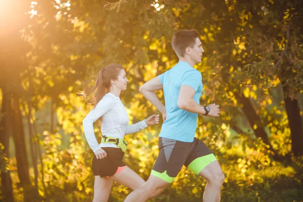 Photo of young athlete woman and man running in park — Stock Photo, Image