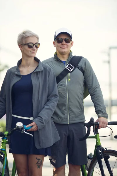 Изображение спортивного мужчины и женщины с велосипедами в парке — стоковое фото