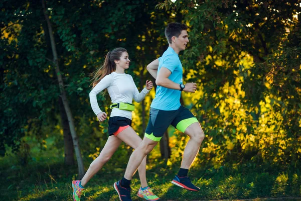 Image of young athlete woman and man running in park — Stock Photo, Image