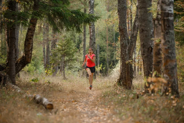 Photo of sports woman running through forest — Stock Photo, Image