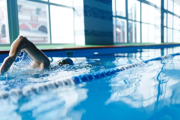 Image of sports man swimming in pool indoors