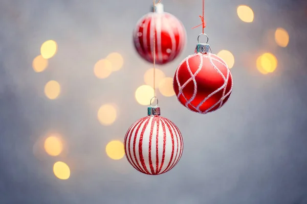 Immagine di tre palline rosse di Natale con motivo su sfondo grigio con luci calde — Foto Stock