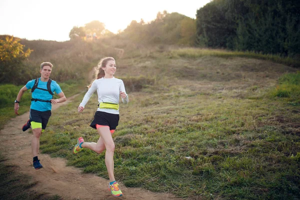 Image of athlete woman and man running through park — Stock Photo, Image