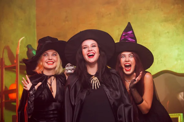 Retrato de tres brujas jóvenes gritando con sombreros negros — Foto de Stock