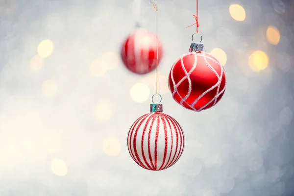 Photo of three Christmas red balls on gray background with spots. — Stock Photo, Image