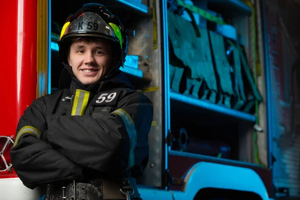 Photo of smiling man firefighter with arms crossed