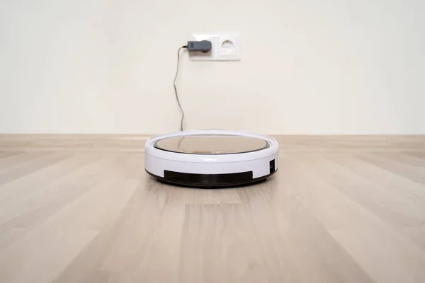 Robot vacuum cleaner on charging dock after it is finished. — Stock Photo, Image