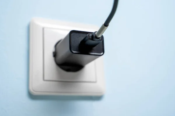 Photo of charger in socket — Stock Photo, Image