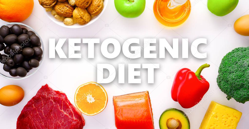 Photo on top of piece of meat, fish, cheese, eggs, vegetables, fruits, olives, walnuts on white background.Ketogenic diet concept.