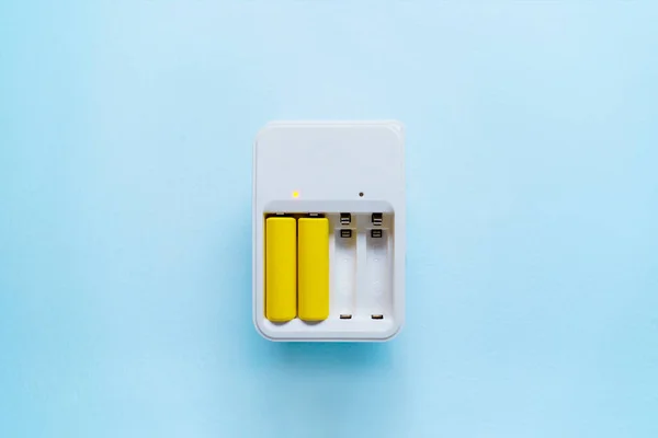 Picture of charger with yellow batteries — Stock Photo, Image