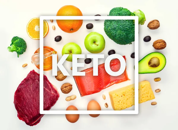 Picture on top of piece of meat, fish, cheese, eggs, vegetables, fruits, olives, walnuts on white background.Ingredients for ketogenic diet. — Stock Photo, Image