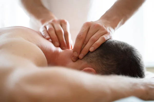 Image of hands masseur doing massage to young male. — Stock Photo, Image