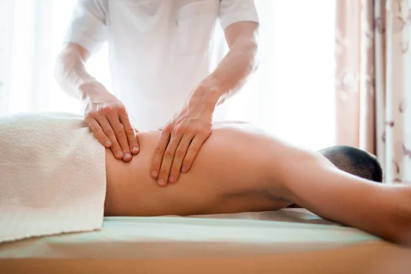 Photo of male massage therapist giving massage to man . — Stock Photo, Image