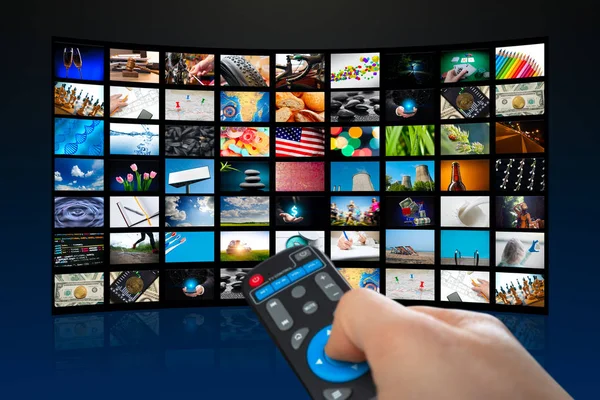 TV screen with lot of pictures and hands of man with remote control on blue background — Stock Photo, Image