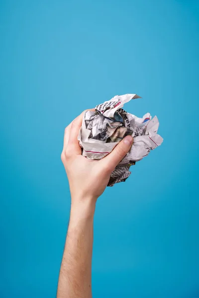 Hand with crumpled newspaper. — Stock Photo, Image