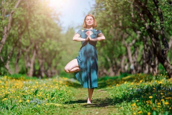 Image of woman in long green dress doing yoga in forest Stock Photo by  ©logoff 274894024