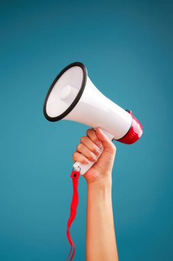 Photo of hand with mouthpiece on empty blue background in studio clipart