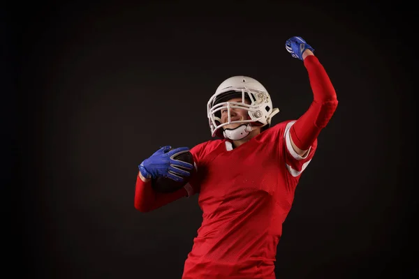 Image of american female football player in helmet with hand raised up