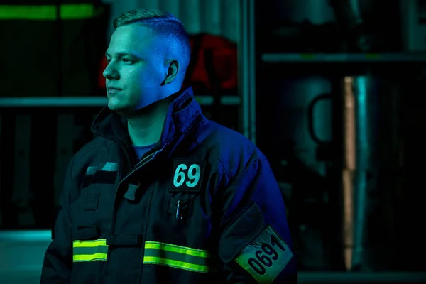 Photo of fireman looking to side , neon effect — Stock Photo, Image