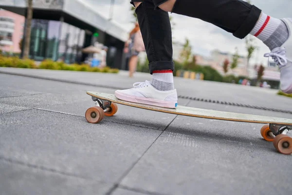 Beeld van de benen van vrouw rijden skateboard op straat in de stad — Stockfoto