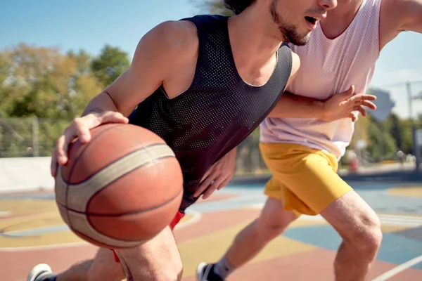 Фото молодых спортсменов, играющих в баскетбол на детской площадке в летний день — стоковое фото