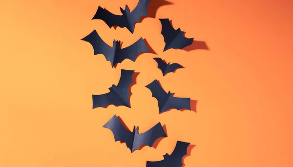 Photo of halloween black bats flying up on blank orange background — Stock Photo, Image