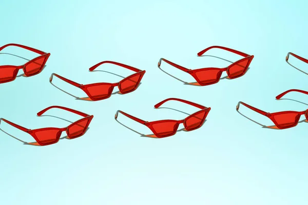 Varias gafas de sol rojas sobre fondo azul en blanco —  Fotos de Stock