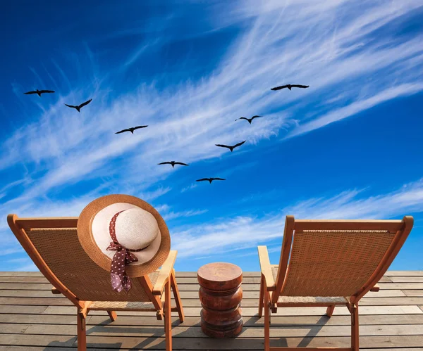 Two Deck Chairs Hat Wooden Platform Migratory Birds Flying High — Stock Photo, Image