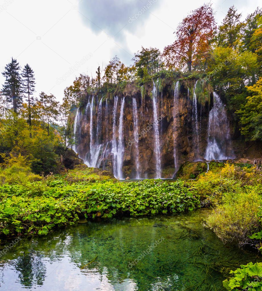 Waterfalls in the Plitvice lakes are reflected in azure water of the lake. Travel to the magic country of Croatia. The concept of ecological, active and phototourism
