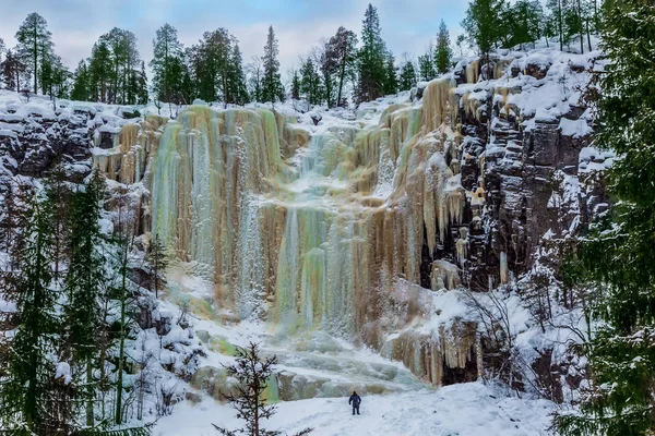 Man -  tourist climbs to a waterfall