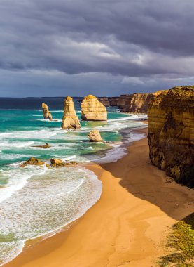 Aktif ve phototourism kavramı. Sabah ışık Melbourne yakınlarında Pasifik kıyısında. Ünlü kayalar okyanus dalgalarının içinde Oniki Havariler sörf