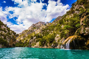 Sudaki yolculuk. Verdon Vadisi 'nin kireçtaşı duvarında küçük sevimli bir şelale. Provence Alpleri, Fransa. Ekolojik ve aktif turizm kavramı