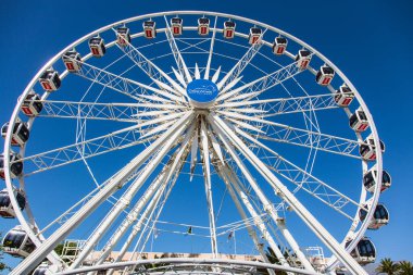 CAPE TOWN, SOUTH AFRICA - APRIL 24, 2016: Great Ferris Wheel. Beautiful sunny day on the ocean shore. Amusement Park in Cape Town Port. The concept of active, exotic and photo tourism