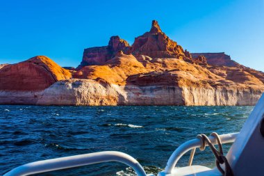Tour on a pleasure tourist boat on an artificial reservoir Lake Powell. Antelope Canyon. Sunset. Grandiose cliffs - red sandstone outcroppings. Concept of active and photo tourism clipart