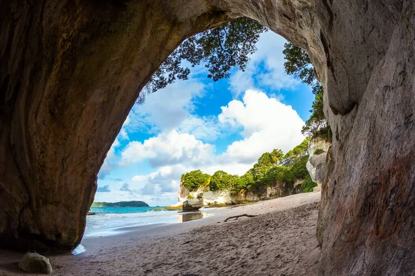 Low tide at sunset. Travel to New Zealand. The magnificent fantastic Cathedral Cave on the sandy beach. The concept of exotic, ecological and photo tourism